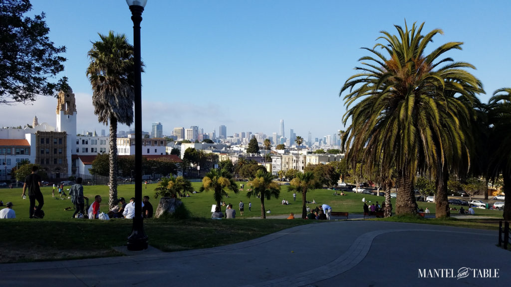 Dolores Park in San Francisco from the top of the hill with the city skyline in the background.