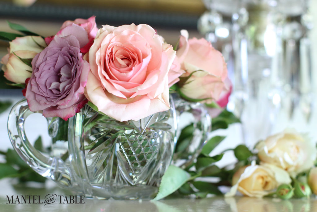 Pink & lavender roses in a heavy cut crystal, two-handled sugar bowl.