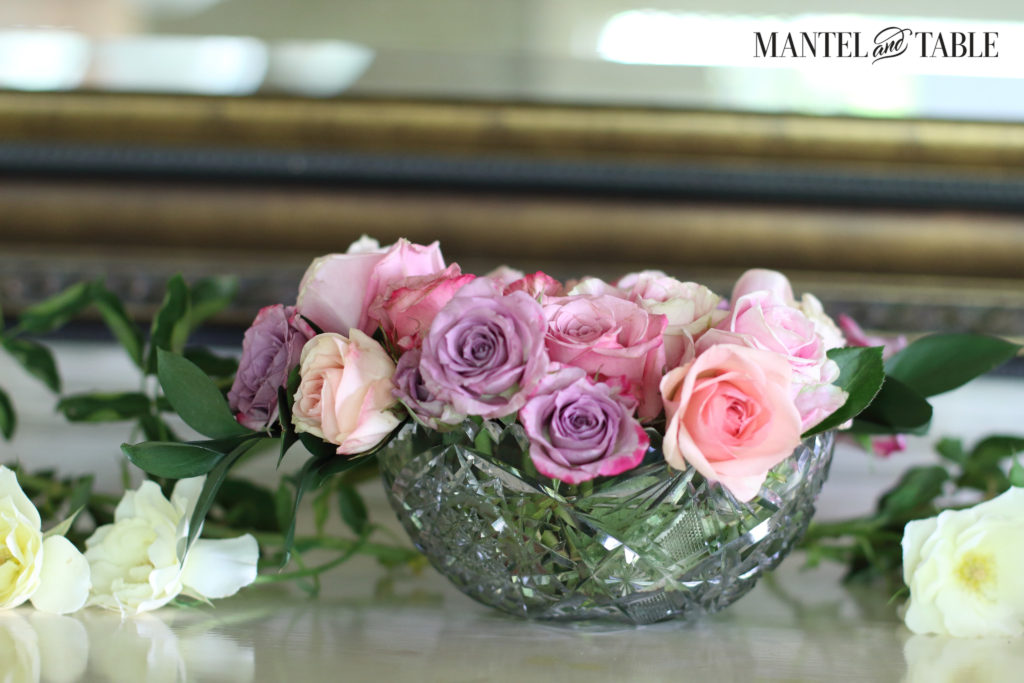 Pastel pink & lavender roses in a round cut crystal bowl.