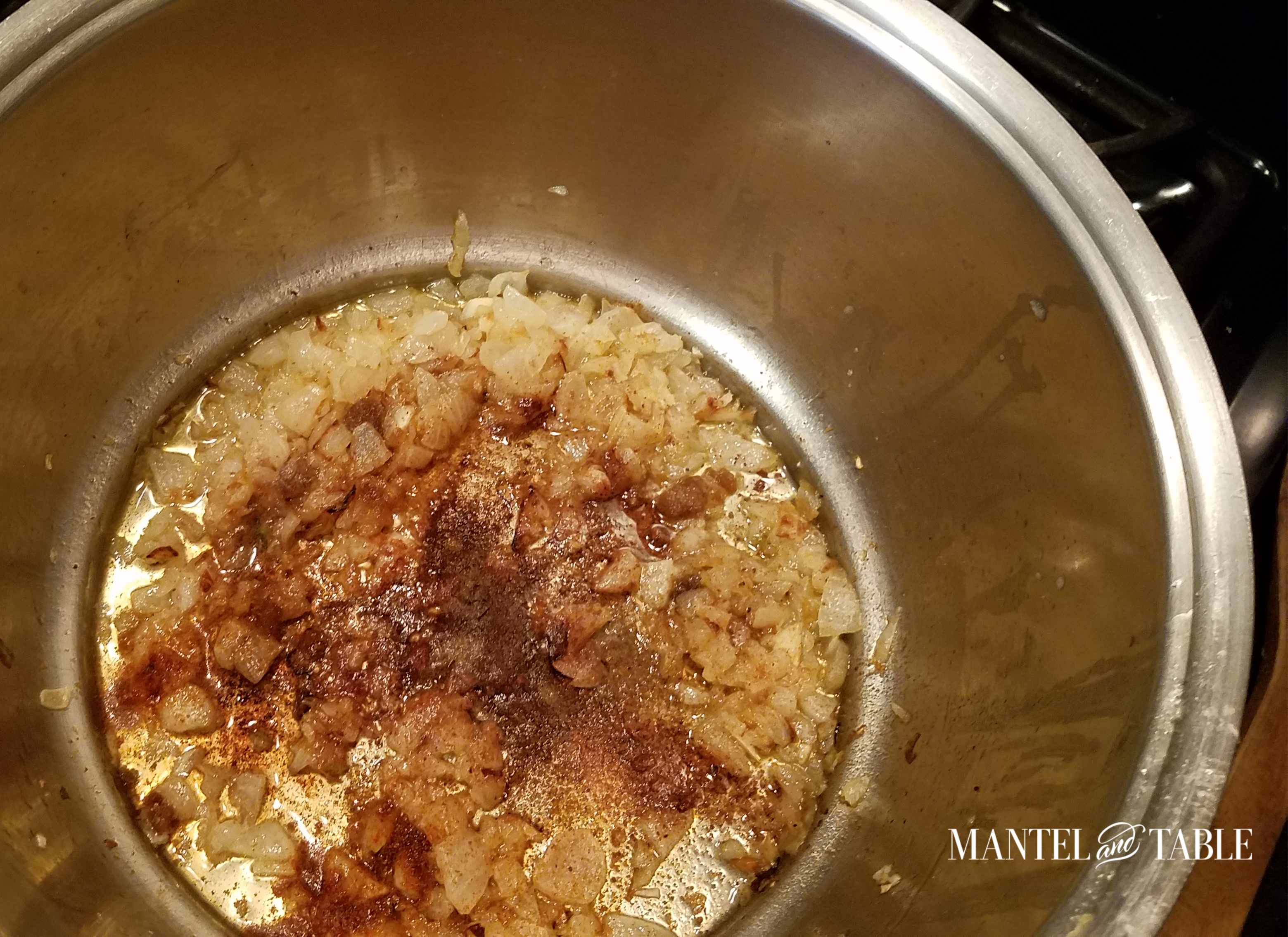 Added spices to the sauted onions in the pot.