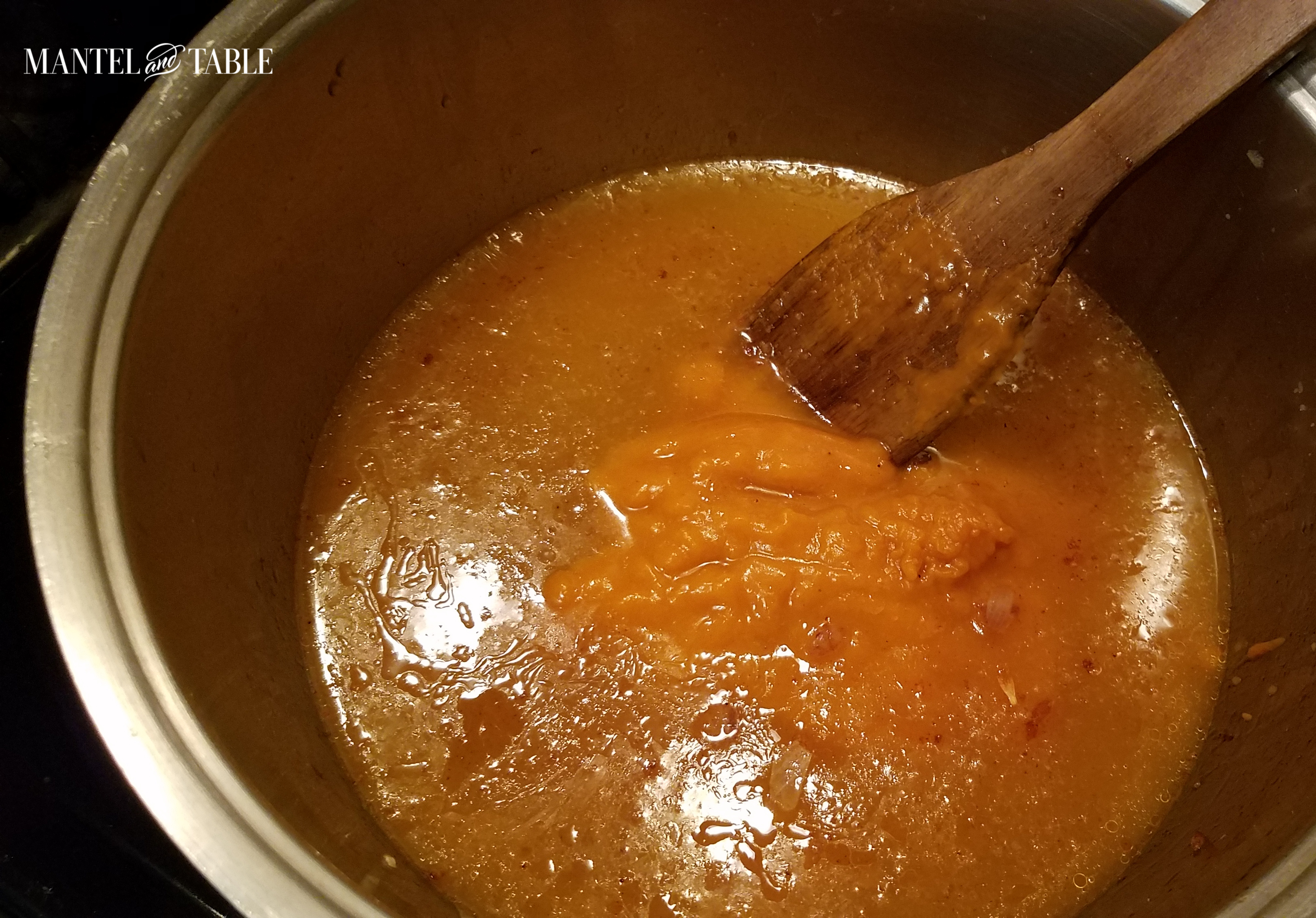 Yummy looking pot full of broth with pumpkin puree