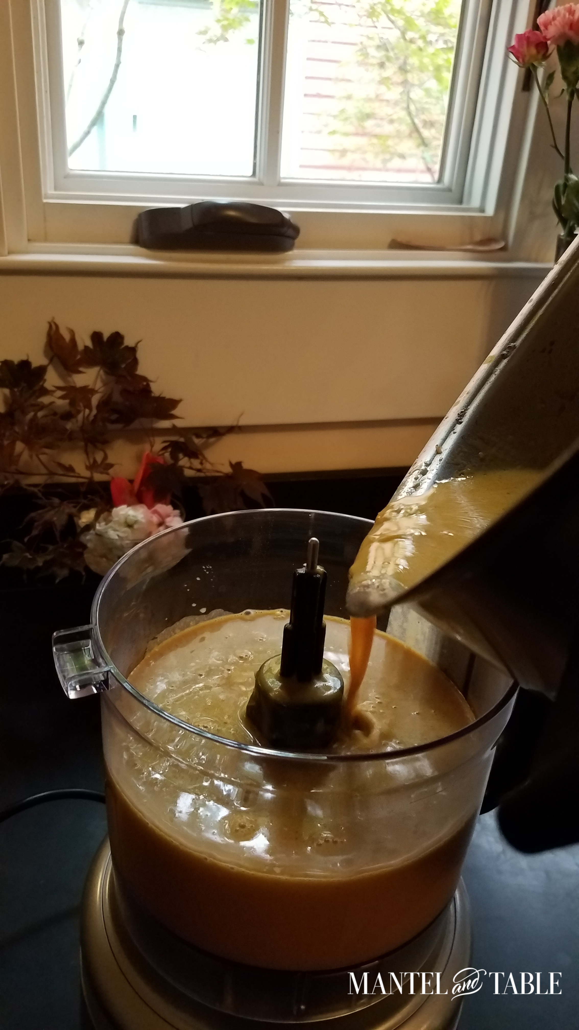 Dumping soup from pan to food processor.