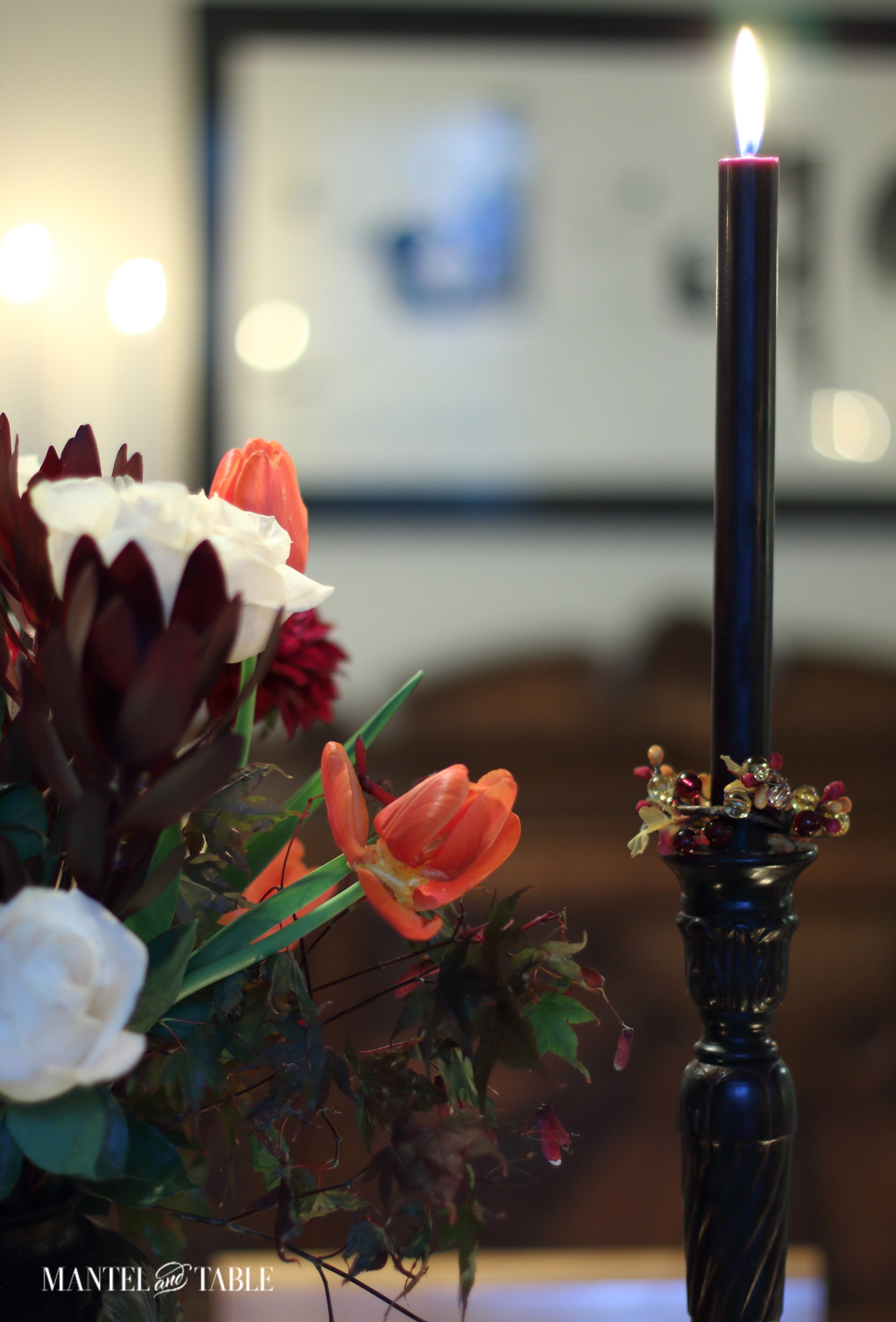 Rubbed bronze candlesticks with black tapers and autumn bead wreath