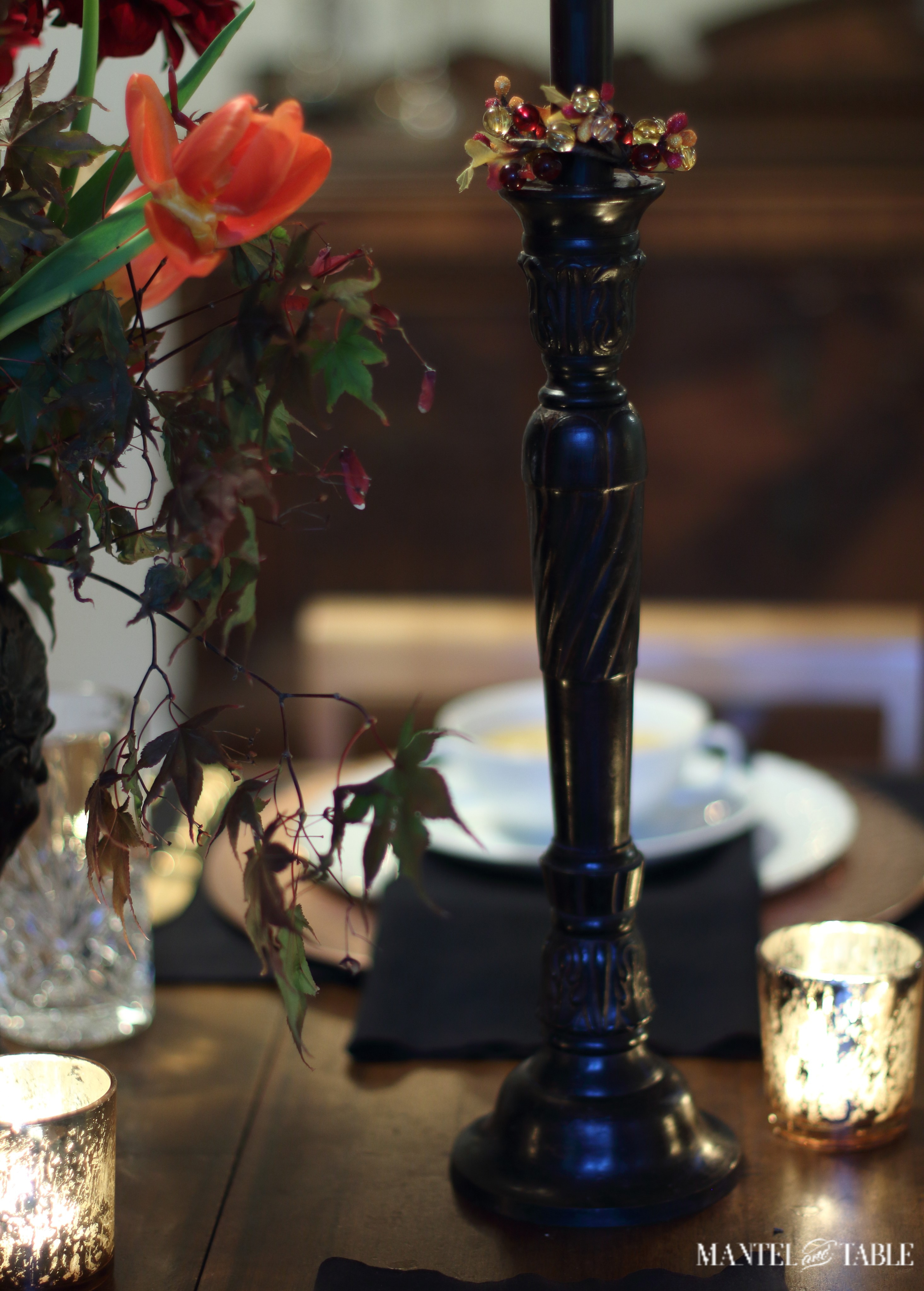 Rubbed bronze candlestick with autumn bead wreath