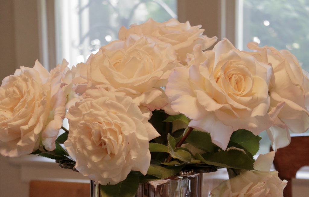 White roses in silver vase