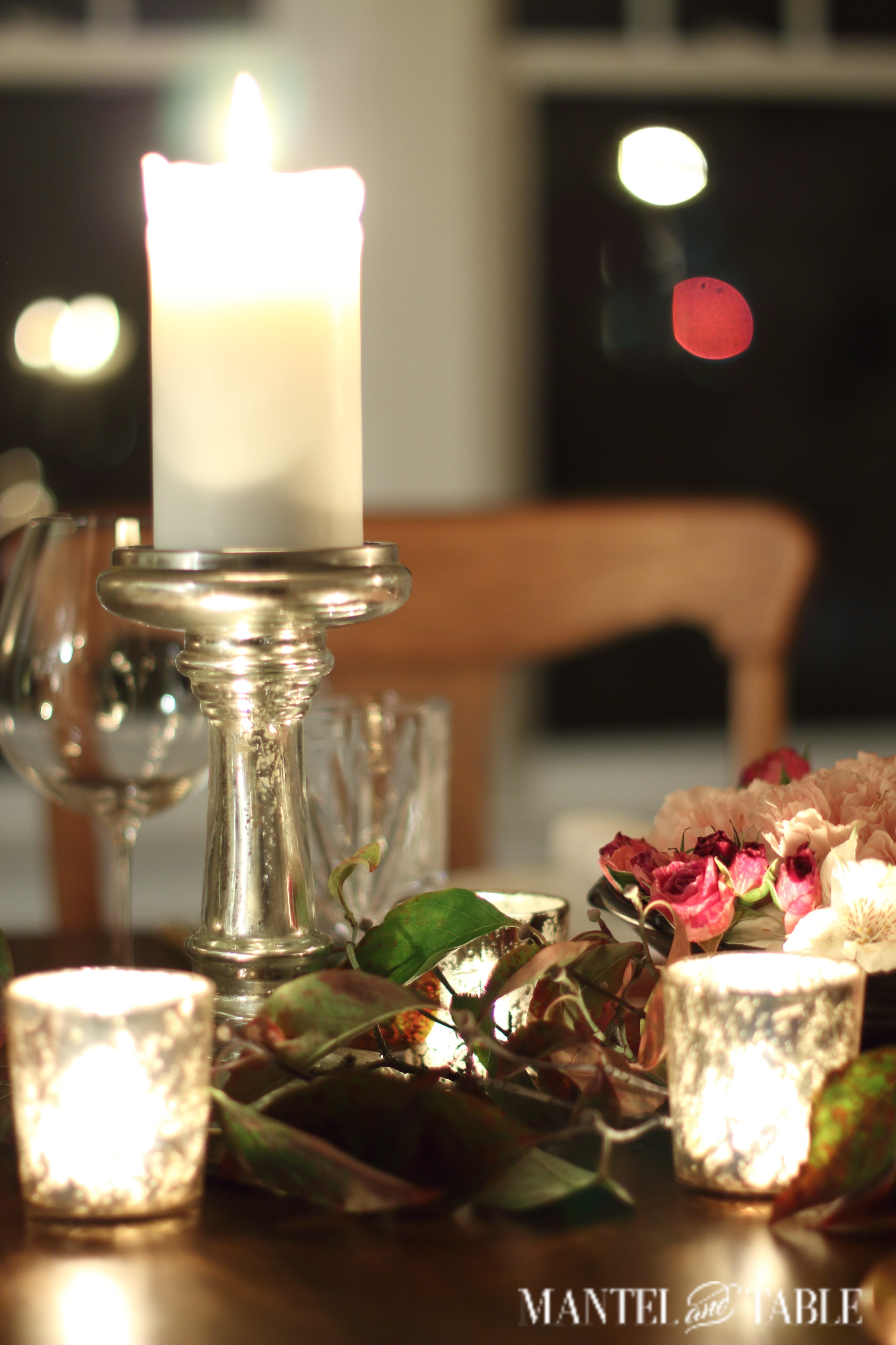 Tall pillar candle on mercury glass holder, copper table setting