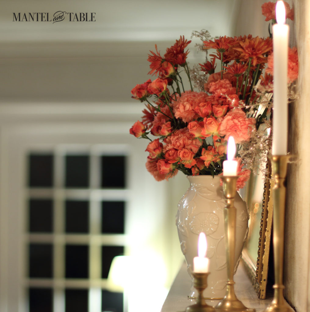 Peach flowers, brass candlesticks glowing, front door