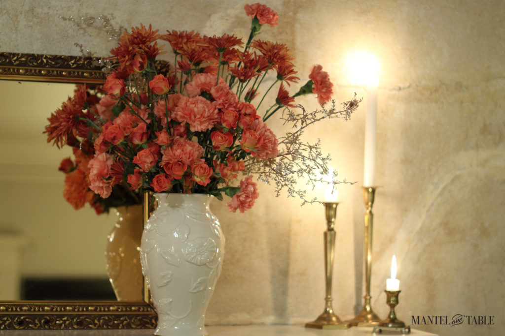 peach flowers, white vase, brass candlesticks