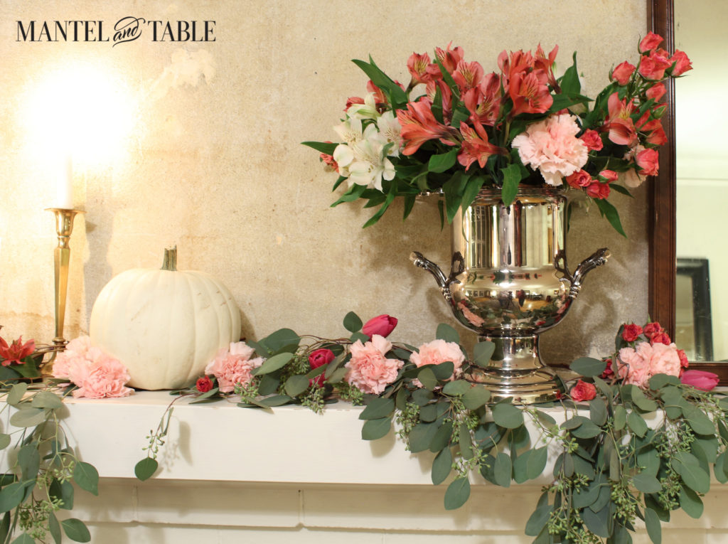 White pumpkins & pink flowers, eucalyptus draped on the mantel