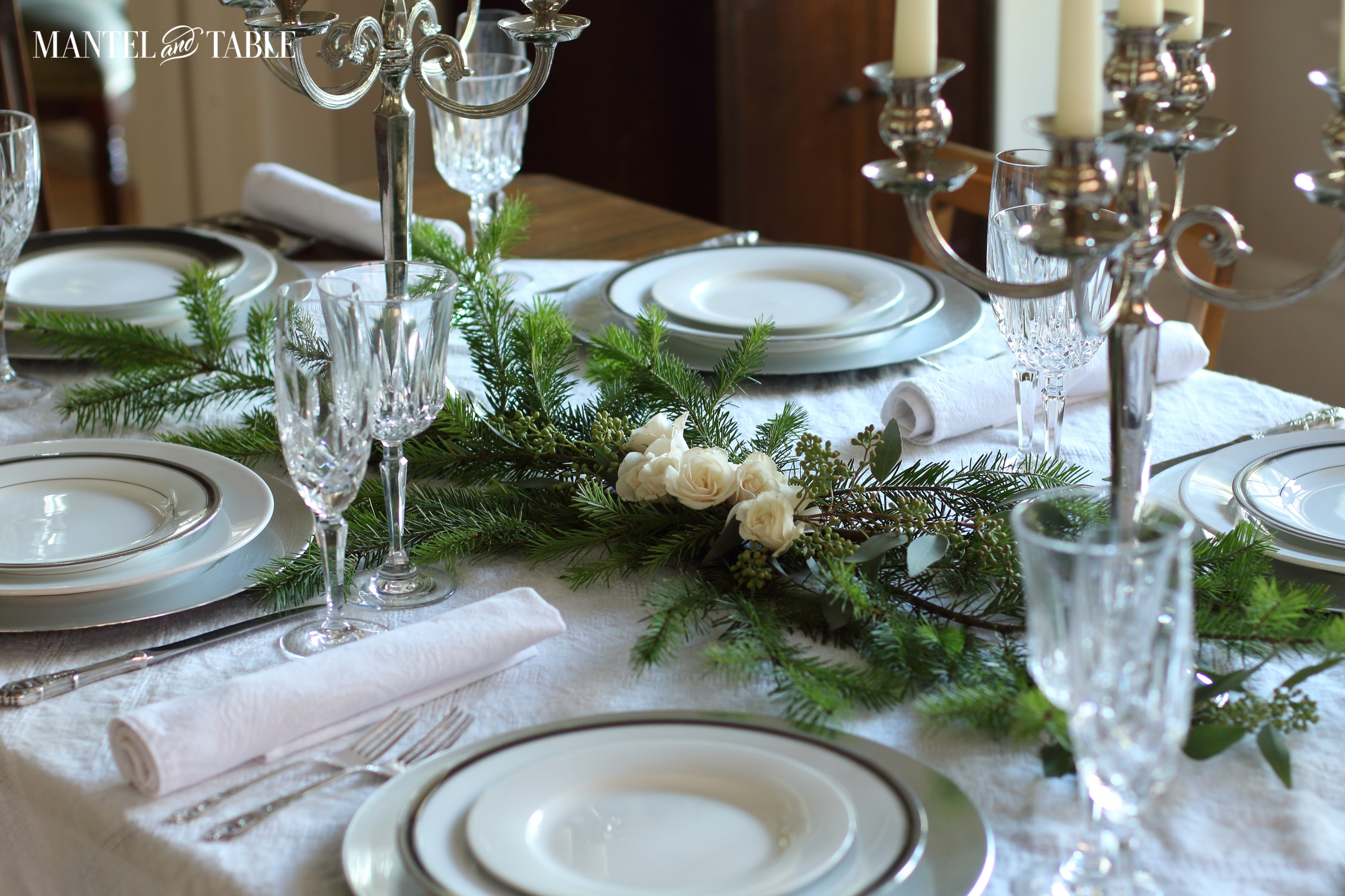 White roses & Evergreen centerpiece with placesettings