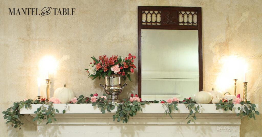 Full mantel with mirror, white pumpkins, pink flowers & candles