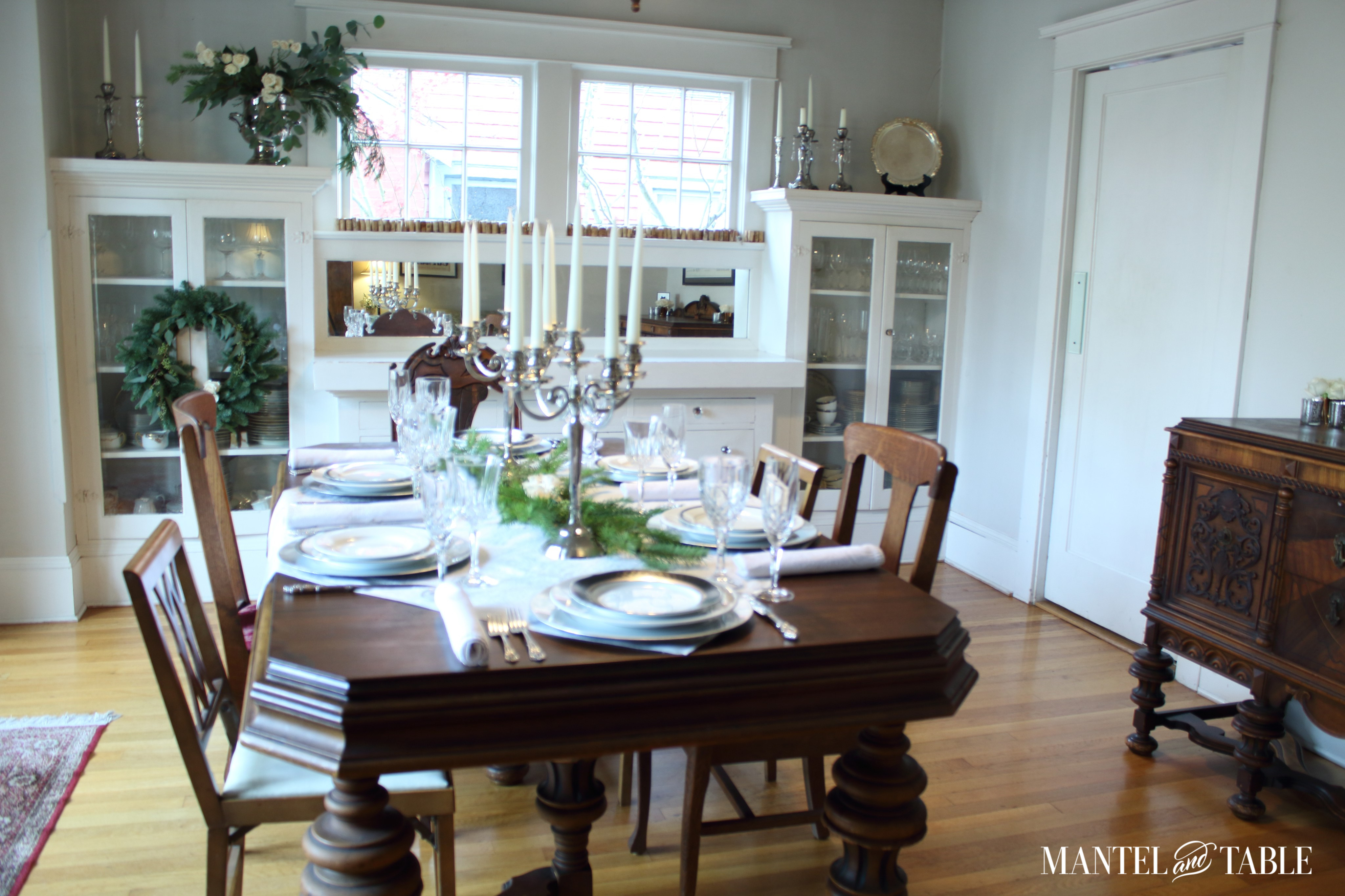 Full room with white tablesetting and evergreen decorations