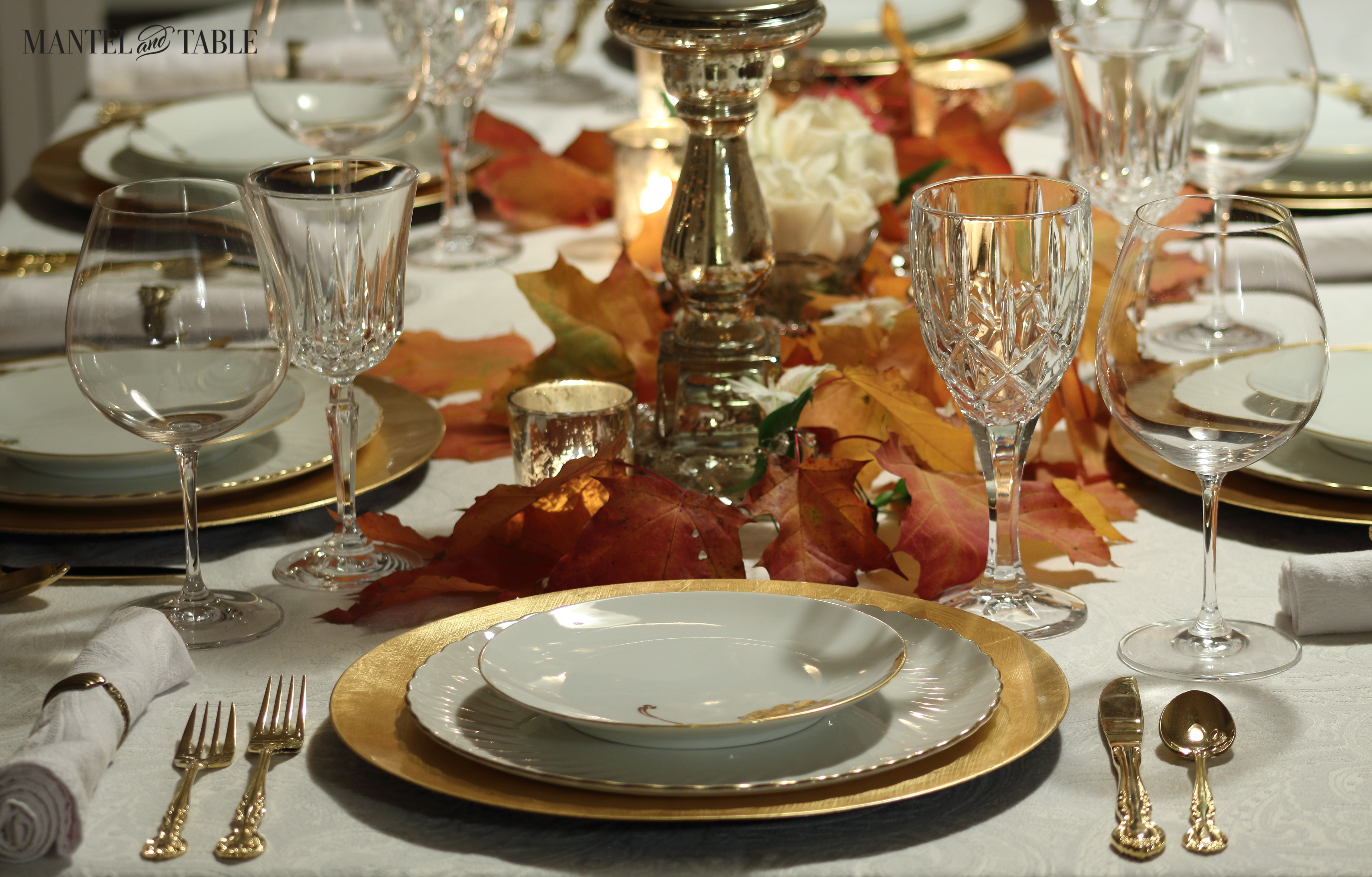 White and gold tablesetting with red & orange fall leaves