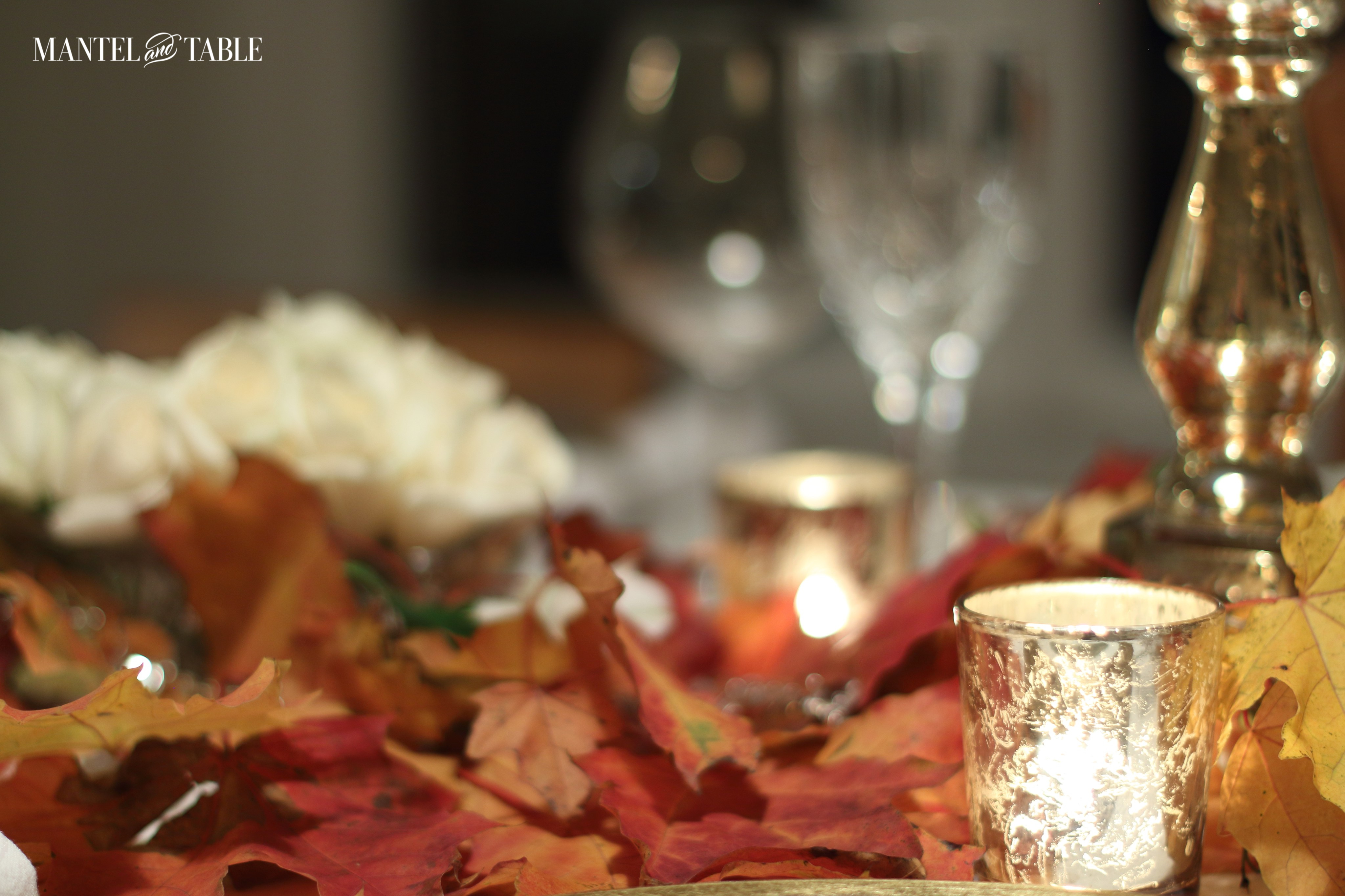 Glowing gold mercury glass votives among the leaves
