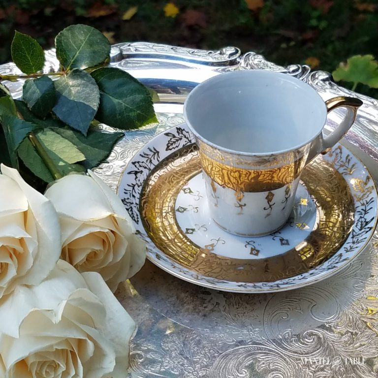 white, gold & silver demitasse cup on silver tray with white roses
