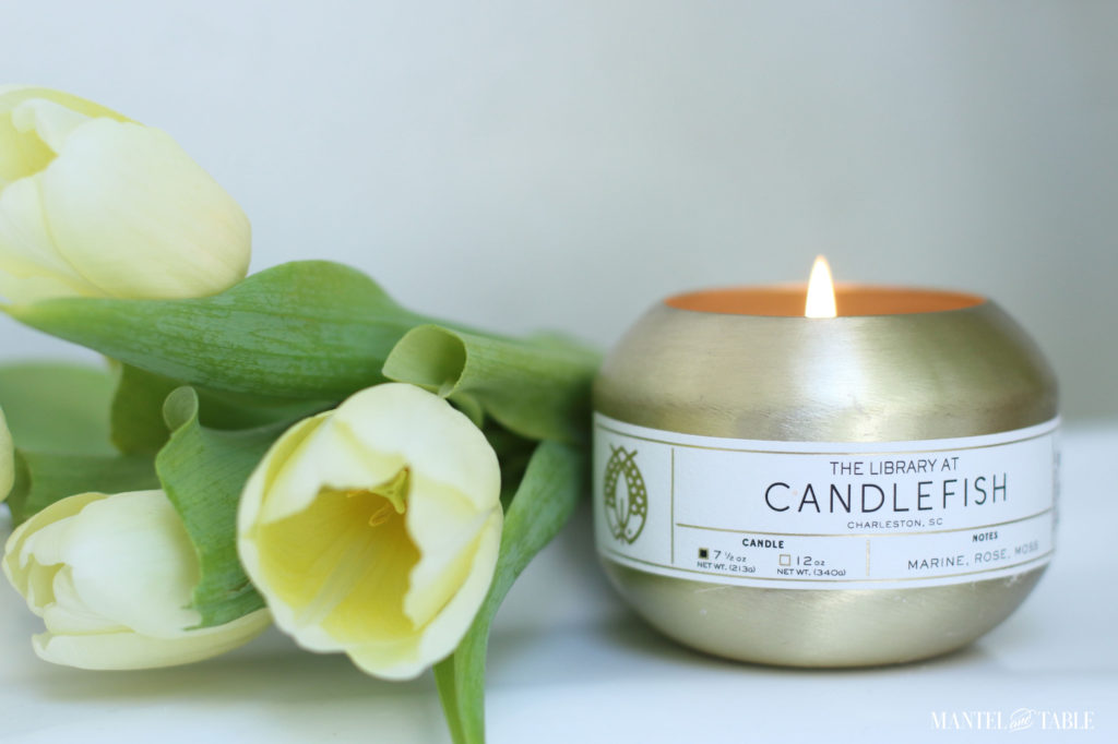 candle in gold pot with yellow tulips