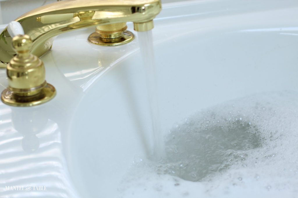 Spa Day ~ Water from gold faucet into white bathtub