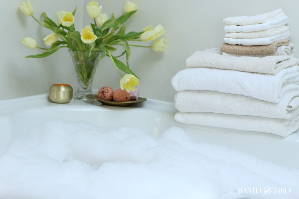 Spa Day ~ bubbles in tub, yellow tulips, white towels, candle