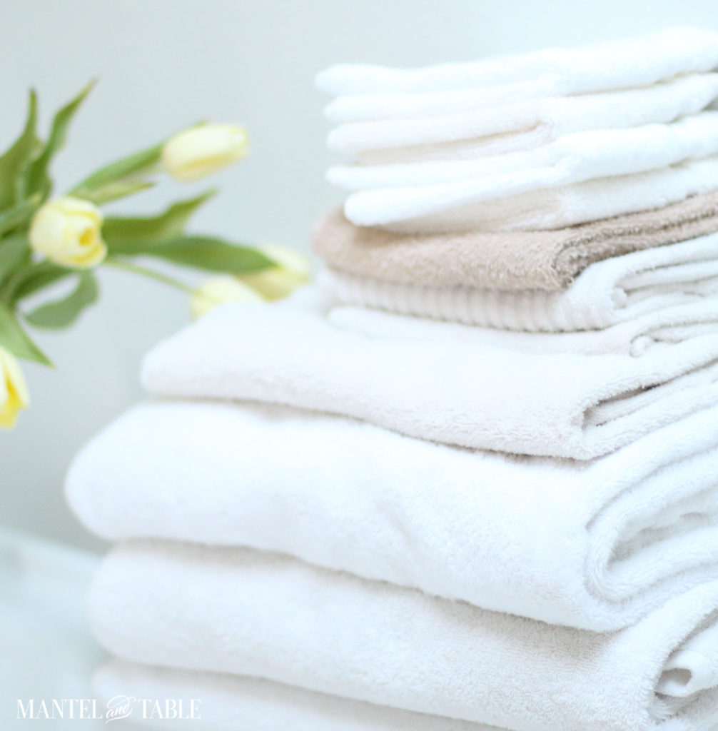 Spa Day ~ stack of fluffy white towels, yellow tulips