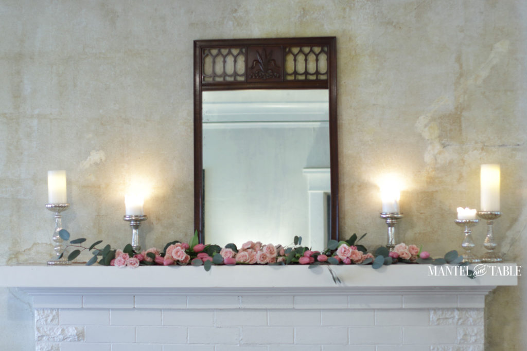 pink flower garland on mantel