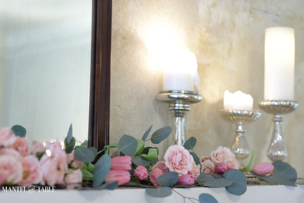 pink rose & tulip garland on mantel with candlelight