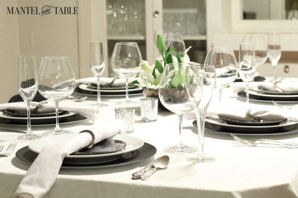 Black & white industrial table setting with centerpiece of white lilies