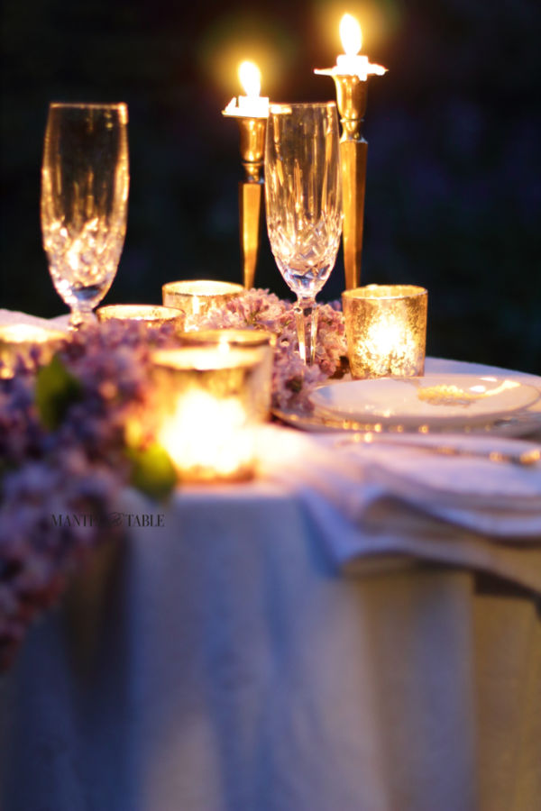 Closeup of outdoor candlelight dinner table
