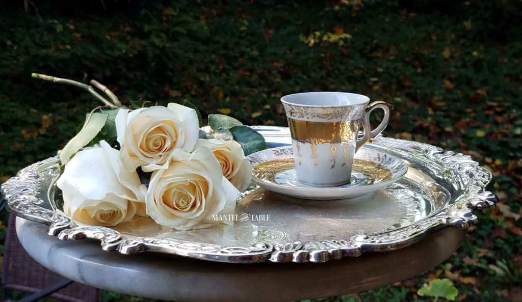 White & Gold demitasse teacup on silver tray with cream colored roses