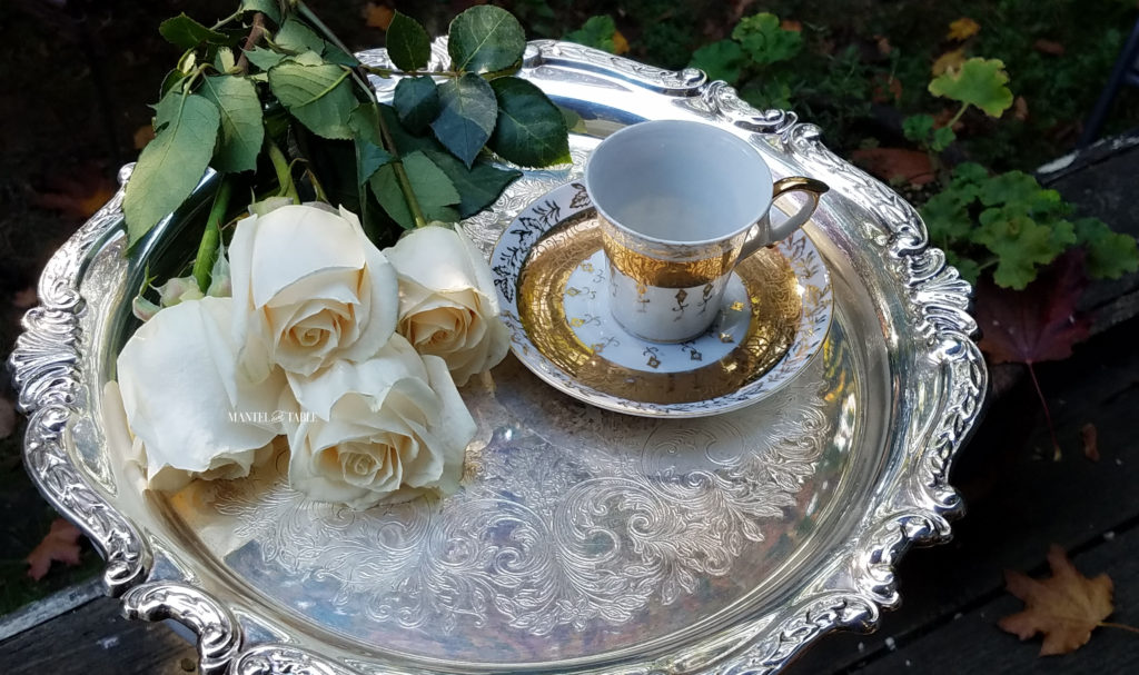 White & Gold demitasse teacup on silver tray with cream colored roses