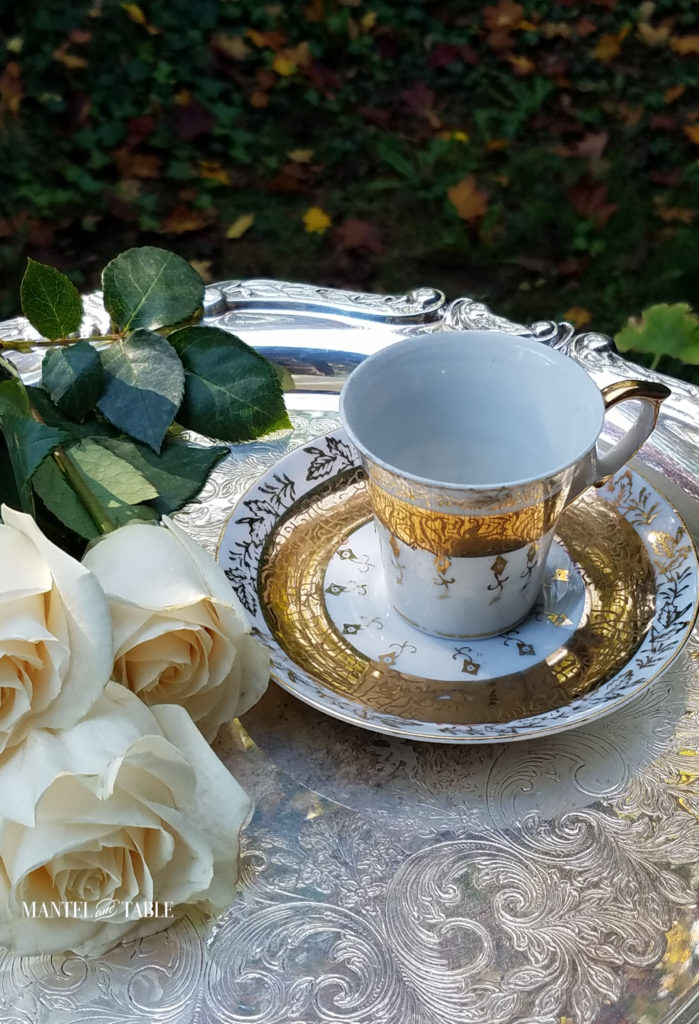 White & Gold demitasse teacup on silver tray with cream colored roses
