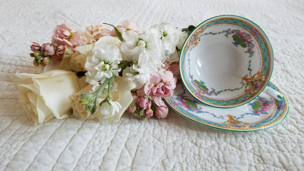 Teal & Pink Royal Worcester teacup on cream quilted background with pastel pink & white flowers