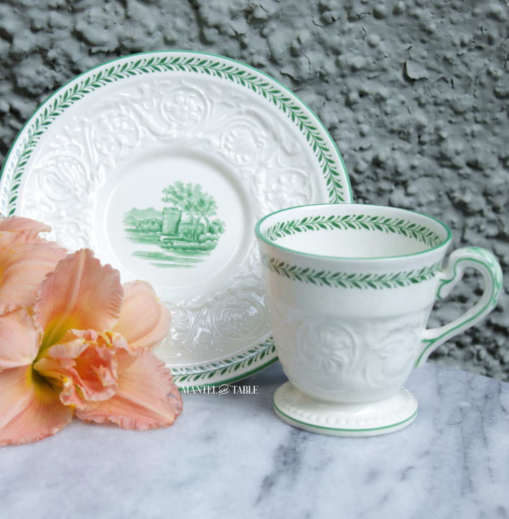 Wedgwood Torbay teacup and saucer. Creamy white with landscape & tower scene in green.