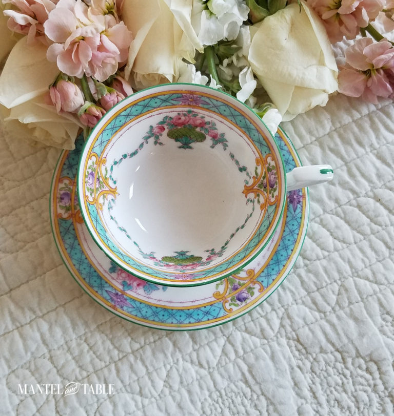 Teal & Pink Royal Worcester teacup on cream quilted background with pastel pink & white flowers