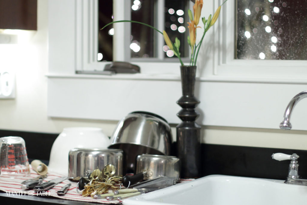Pots and pans drying on the counter beside the sink
