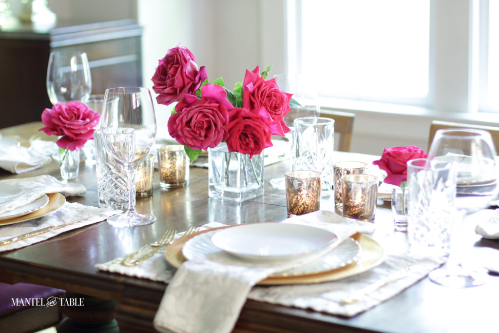 Blush and gold tablescape with deep pink roses