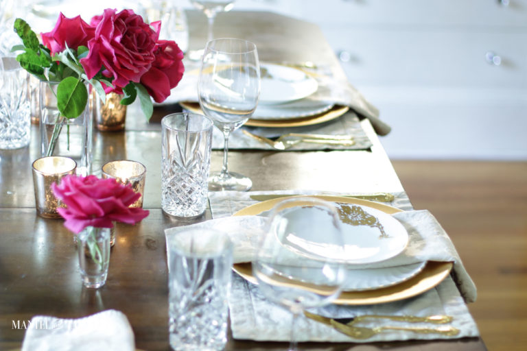 Two place setting of blush and gold with deep pink roses
