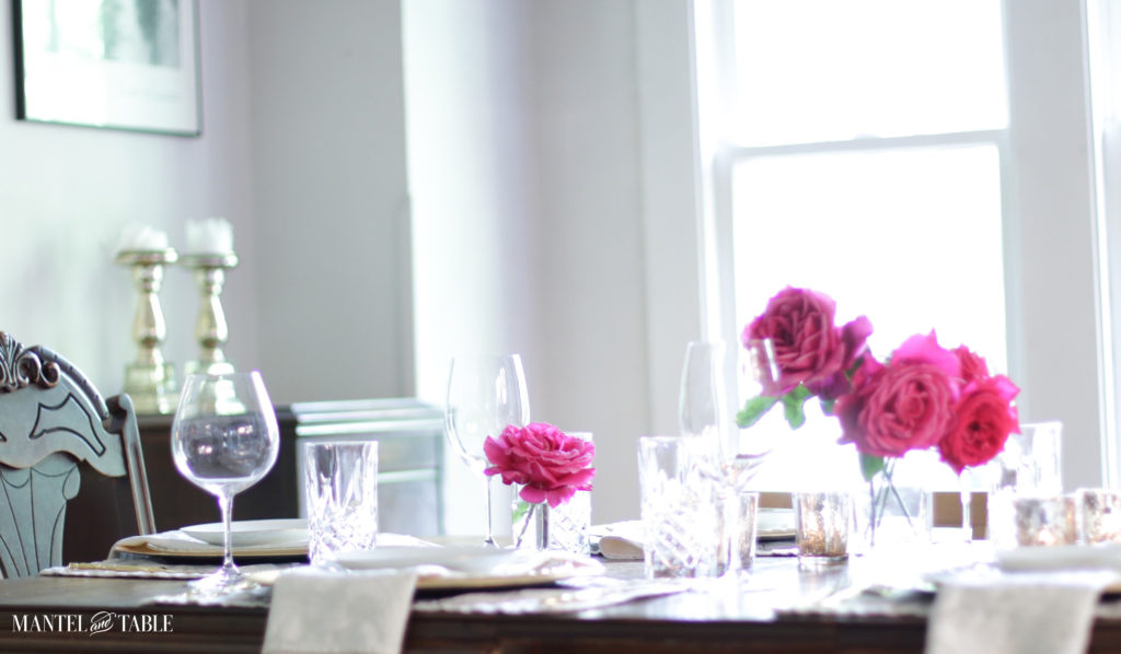 Side view of table setting with deep pink garden roses