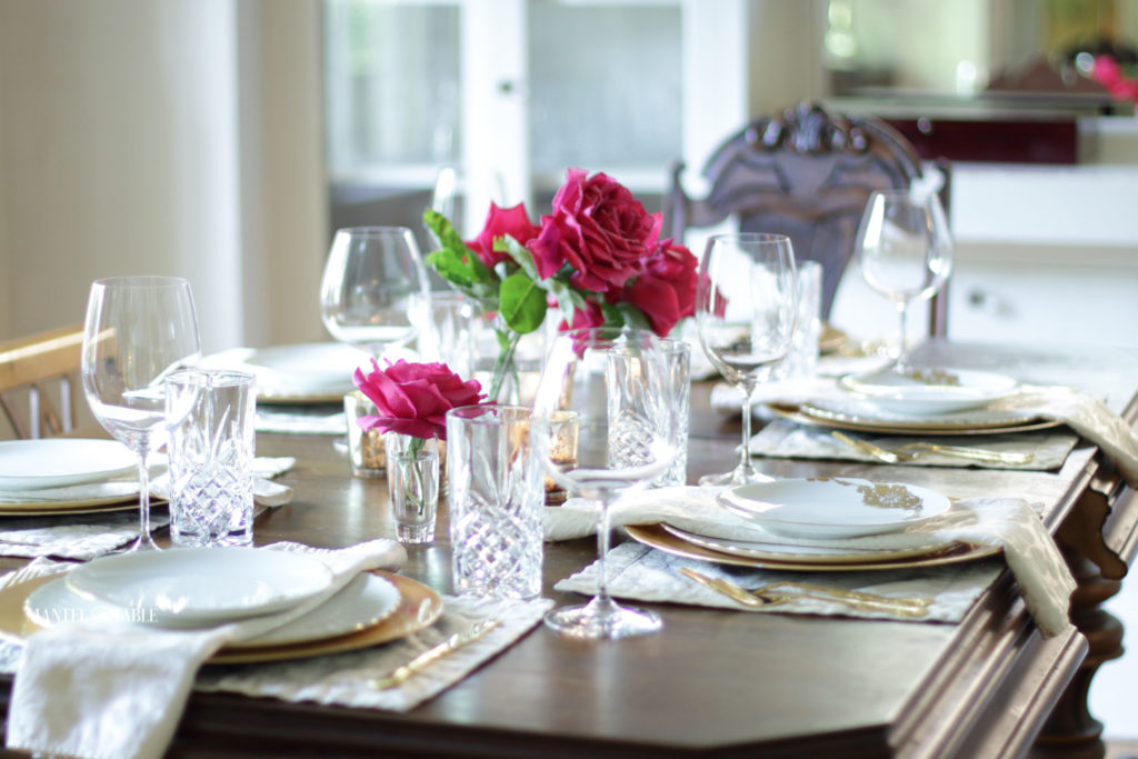 White and gold table setting with deep pink roses