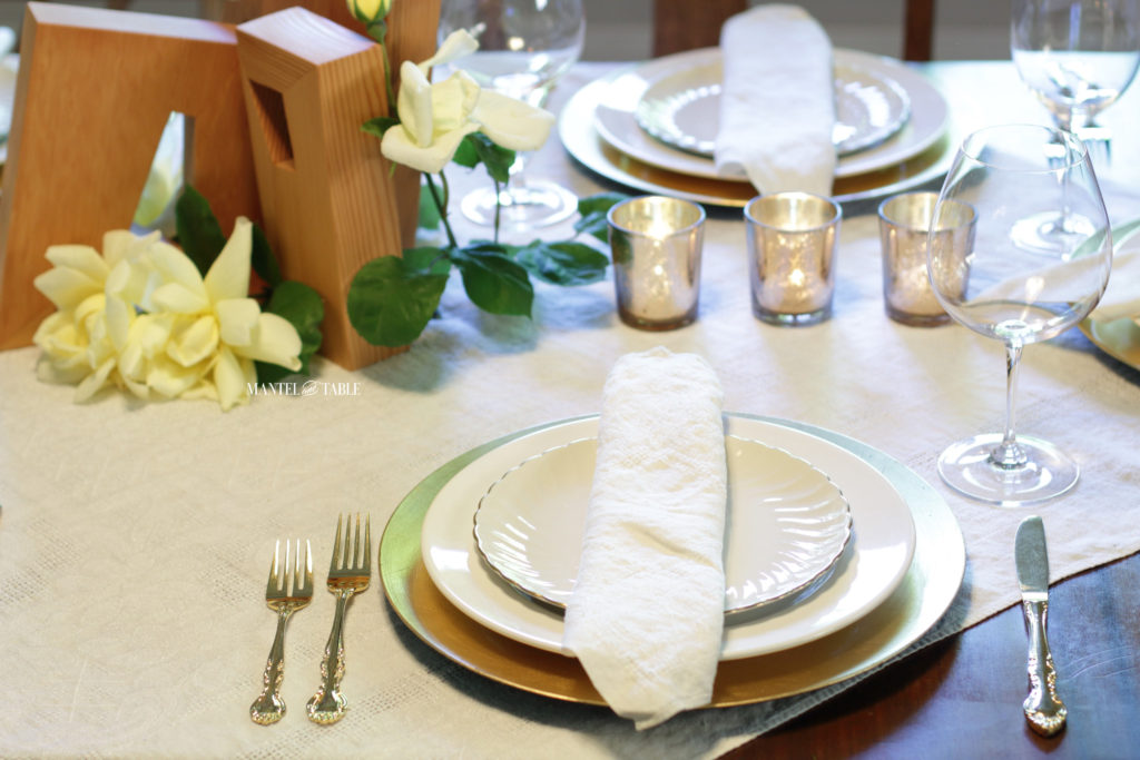 Gold & White place setting, centerpiece, row of gold votive candles