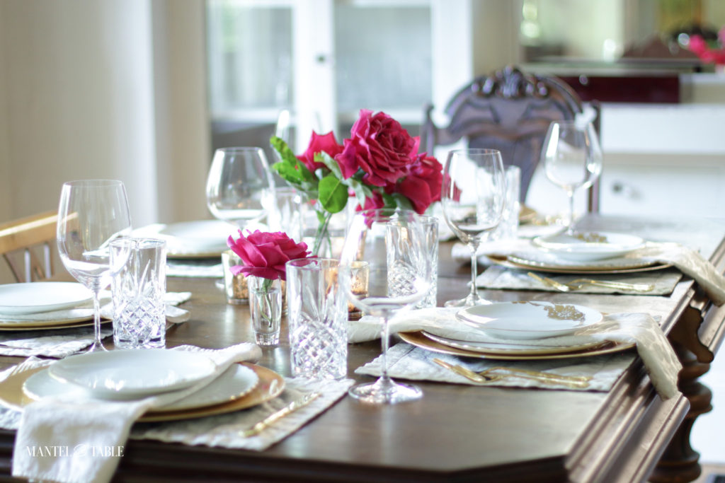 Full blush and gold table setting with deep pink roses