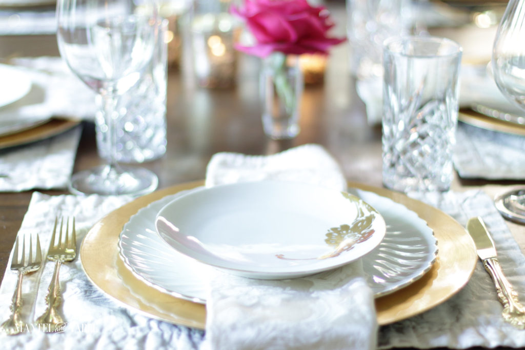 Closeup of white, blush, and gold place setting