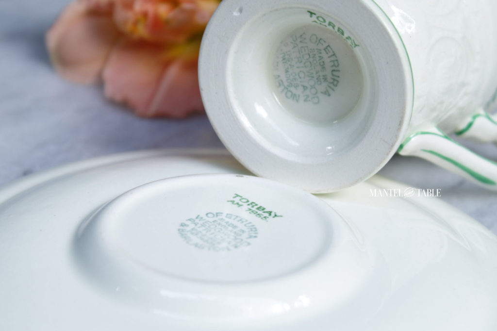Underside of teacup and saucer showing maker's marks.