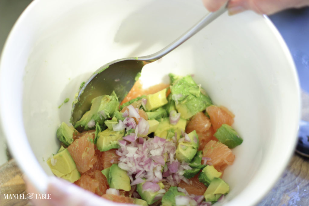 White bowl with grapefruit avocado salad mixture