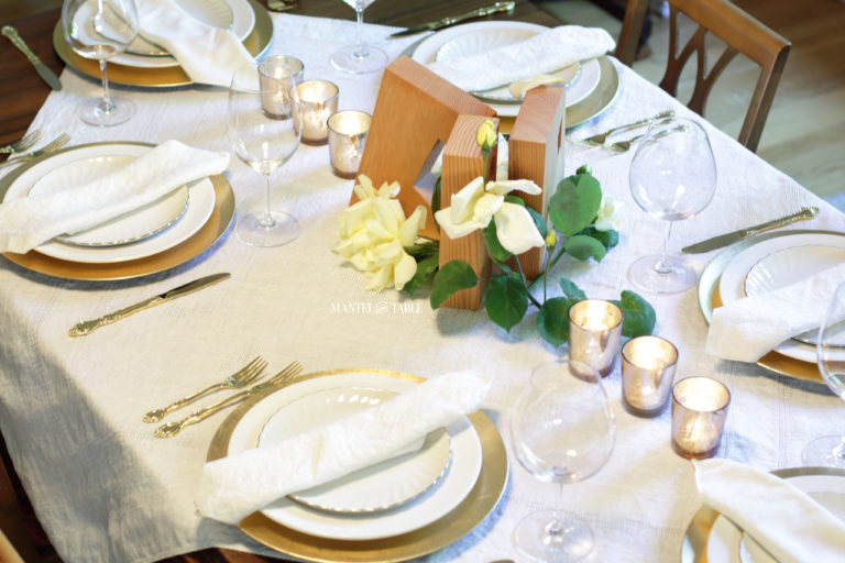 Table setting with 3 angular rectangular blocks with geometric cutouts as a centerpiece.