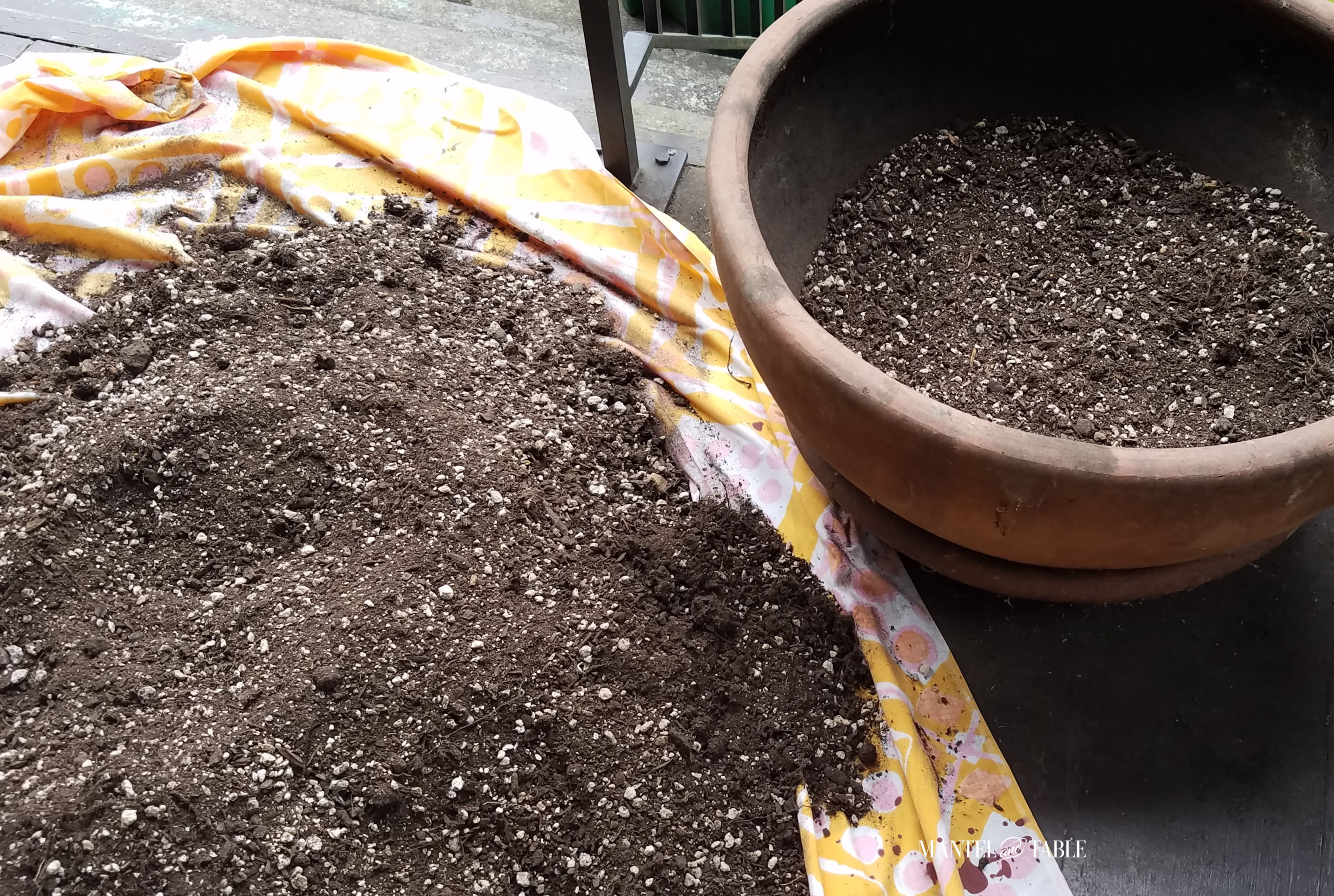 big pile of soil and partially filled planter