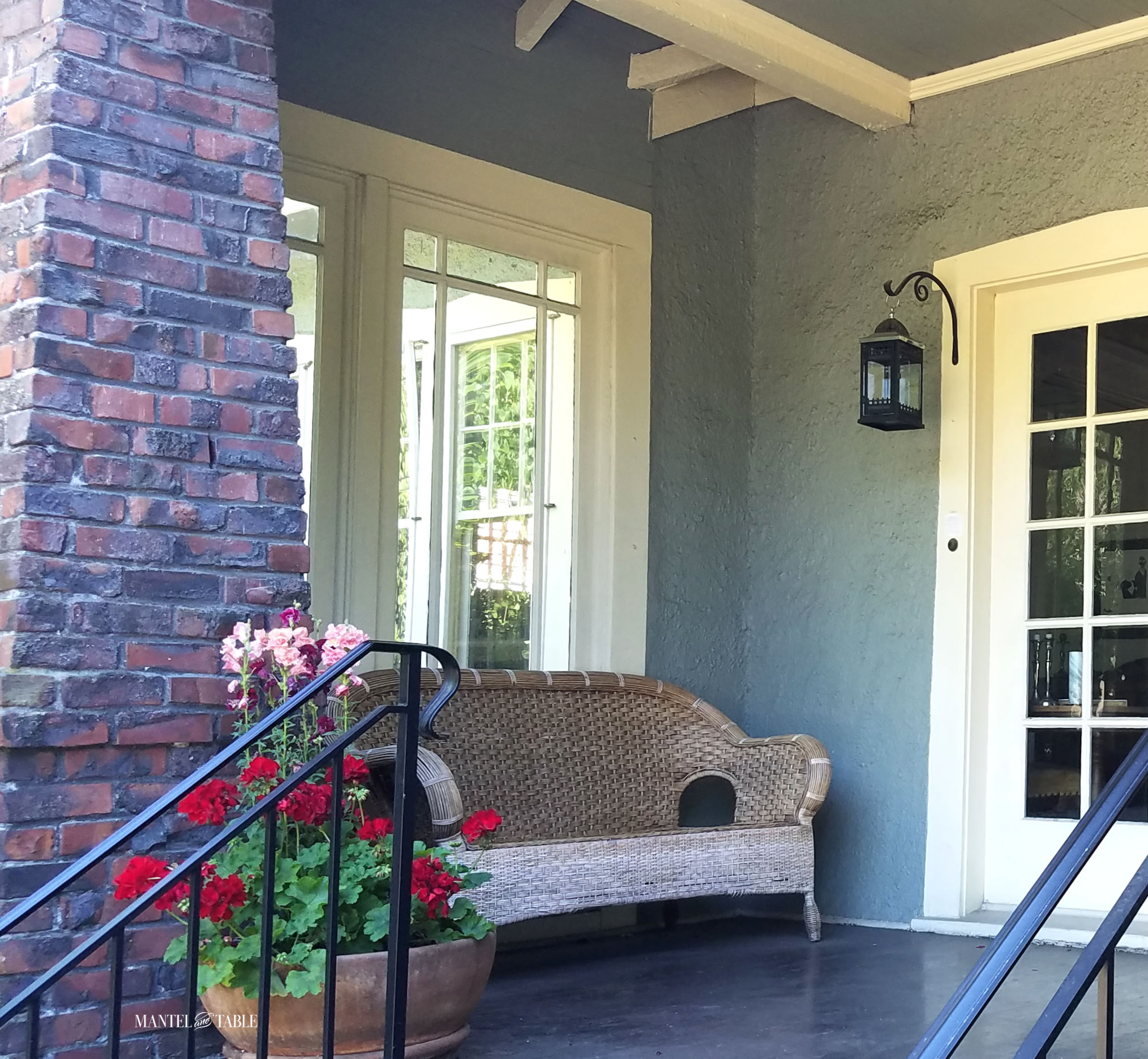 Porch planter with wicker love seat on the porch
