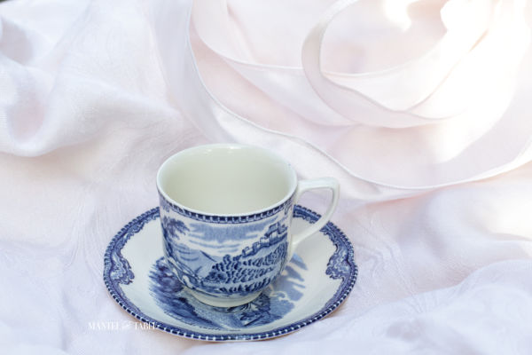 Old Britain Castles Blue Teacup and saucer on pink.