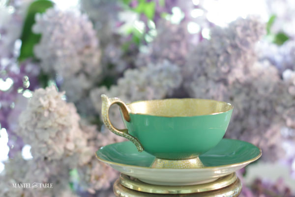 Aynsely green & gold teacup with lilacs and wisteria background
