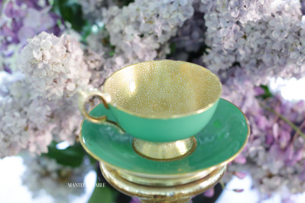 teacup top view with vase of lilacs
