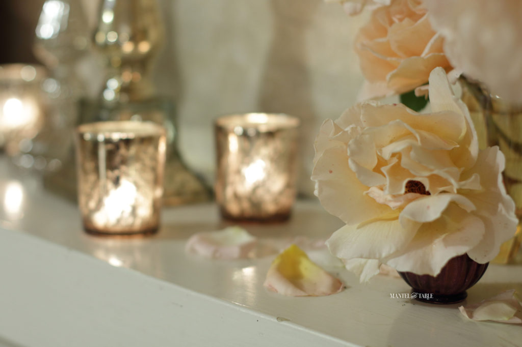 Peach garden roses in tiny vases, gold votive candle holders